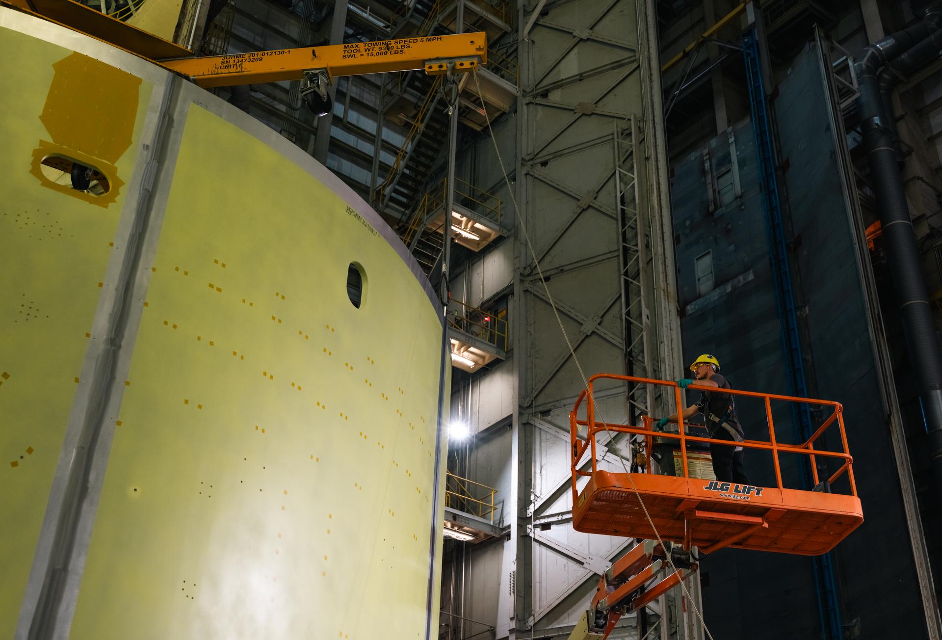 Teams at Michoud Assembly Facility in New Orleans load the engine section barrel into the vertical assembly center on Aug. 5, 2026. The engine section will be used on the SLS (Space Launch System) rocket’s core stage for the agency’s Artemis V mission. On the vertical assembly center tooling, teams will mate the flight hardware to a ring, which will serve as an attachment point for the liquid hydrogen tank later in the production process. The engine section is one of five major elements that make up the 212-foot-tall SLS rocket stage; and houses various avionic systems, the engine thrust structure, and four RS-25 engines. The core stage produces more than two million pounds of thrust to help launch NASA’s Orion spacecraft, astronauts, and supplies beyond Earth’s orbit and to the lunar surface for Artemis.